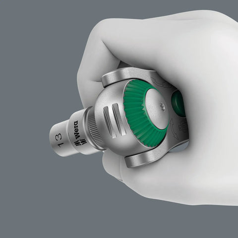 Close-up of hand holding Zyklop 8000 C Half Inch Drive Ratchet With Five Tools In One, showcasing green gear and swivel head.