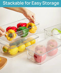 Top Shelf Eight Piece Clear Stackable Storage Bins With Slick Snap Lids Go To Fridge Organizers holding bell peppers, lemons, and apples.