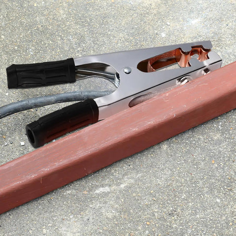 Heavy Duty Welding Ground Clamp With Copper And Iron Build Designed For Secure Earth Connection Plus Strong Load Bearing Capabilities To Keep Your Setup Safe And Steady While Getting Work Done Any Day on a wooden surface.