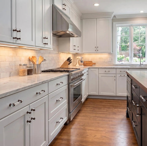 Modern kitchen featuring oil rubbed bronze glass cabinet pulls with 3 inch centers on white cabinets with silver appliances.