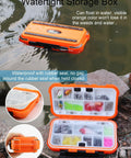 Small Kayak Tackle Box Waterproof Mini Lure Box With Sealed Rubber Gasket floating on water, showing orange color and compartments.