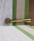 Stair Carpet Holder Clip with floral design in brass, holding a runner in place on a stair, part of a 5-inch pack of 13 clips.