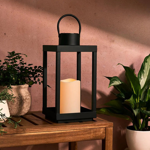 Outdoor Solar Lantern For Porch And Patio, Large Black Metal Lantern With Waterproof LED Candle, 14 Inches on wooden table
