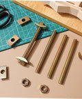 Professional Grade Furniture Connector Bolts 12 Pack Flat Head Wood Joiner Kit For Countertop Setup And Laminate Mounting on a work surface.