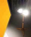 Twin 500 Watt Portable Halogen Work Light With Telescoping Stand, bright illumination in dim garage setting.