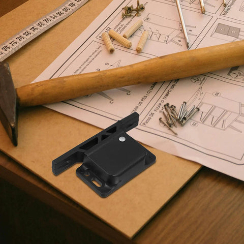 RV Cabinet Door Latch Set With Spring Hook Lock Design next to hammer and screws on a table