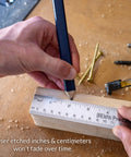 Hand using stainless steel ruler set three pack with one 6 inch and two 12 inch metal straight edges for measuring and drawing built tough.