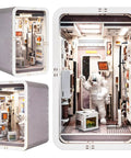 Space Capsule Book Nook Kit With LED Light, DIY Dollhouse Miniature Shelf Insert showcasing astronaut scene inside.