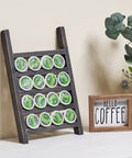 Countertop K Cup Holder For Your Dope Coffee Bar, Rustic Wood Pod Organizer, holds 20 K Cups, displayed with a coffee sign and plant