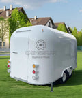 Custom Stainless Steel Food Truck Trailer With Turnkey Kitchen Setup For Mobile Coffee Or Hot Dog Business Built Heavy Duty To Level Up Your Street Vendor Hustle Today, viewed from the rear on grass.