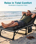 Man relaxing on Heavy Duty Outdoor Tanning Chair With 5 Position Folding Chaise Lounge And Pad on a beach.