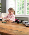 Child playing with CASE SV340B Skid Steer Loader Toy Set With Flatbed Trailer RAM Pickup Horse Trailer And Two Horses