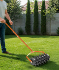 Man using Beast Heavy Duty 18 Inch Manual Lawn Aerator Roller with 49 Inch Adjustable Handle Spike Aerator for Deep Soil Penetration