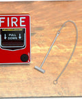 Emergency Stainless Steel Fire Alarm Button Hammer For Industrial Use displayed beside a fire alarm pull station on wood surface.