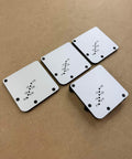 Must Have Cutting Board Foot Jig For Woodworking That Delivers Fast Precise Marking Drilling Or Punching One Eighth Inch Holes With A Heavy Duty 7mm Phenolic Locating Plate Built To Last, showing front view of four white phenolic plates with hole markings on a wooden surface.