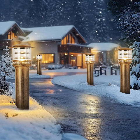 Weatherproof Aluminum Post Cap Lights For Deck And Yard With Bright Acrylic Diffuser illuminating a snowy pathway outside a home.