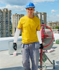 Built Tough Cut Resistant Forearm Sleeves Featuring Sweat Wicking HPPE And Reinforced Fiberglass Weave worn by worker at construction site.