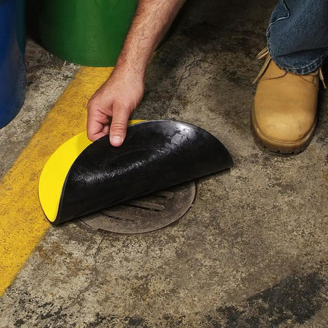 Person placing Beefy Heavy Duty Storm Drain Cover For Round Drains Up To 6 Inches Diameter on outdoor drain, showing vinyl top.