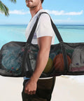 Person carrying Oversized Mesh Dive Bag Duffle For Scuba Gear With Shoulder Strap And Carabiner Keychain on beach