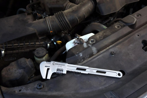 15 Inch Automotive Adjustable Wrench With Sliding Jaw For General Purpose And Car Repairs resting on car engine