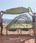 Heavy Duty XXL Camping Cot For Adults With Pivot Arm Easy Setup shown in use at a campsite with green tent cover