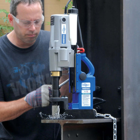 Front view of Hougen HMD905 115V magnetic drill with coolant bottle mounted on a metal worktable