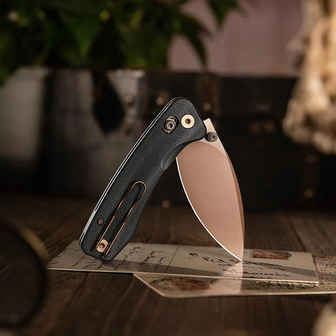 Koala Plus-BM Folding Knife With 2.99 Inch Blade For EDC And Camping, shown with black micarta handle and bronze blade.