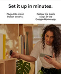 Person setting up Indoor Nest Security Camera 1080p Wired 2nd Generation Snow Color with a smartphone app