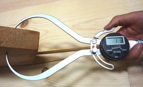 Person using 8 Inch Digital Outside Caliper With Big Readout, Switch Between Inch, Metric Or Fraction, Handy Hold Function on wood.