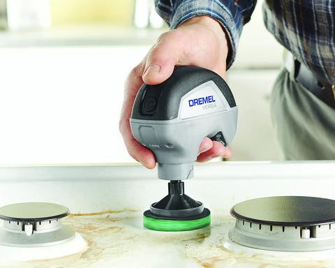 16 Piece Versa Power Scrubber Accessory Value Kit in use on kitchen stovetop, highlighting cleaning pad on heavy grime.