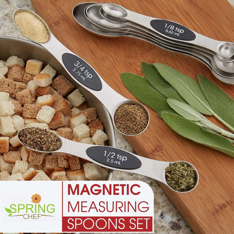 Magnetic Stainless Steel Measuring Spoons Set 8 Pieces With Leveler, displayed with spices and herbs on kitchen counter, Black.