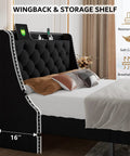 Queen Upholstered Bed Frame With 16 Inch Wingback Headboard And Built In Dual Charging Station Button Tufted Platform Base Solid Wood Slat Support No Box Spring Needed Zero Hassle Setup Black displayed with storage shelf and soft cushion.