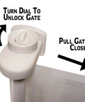 Close-up of the retractable indoor outdoor pet safety gate for doorways and stairs up to 54 inches, showing latch and operation instructions.