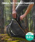 Person placing On The Go 10W Foldable Solar Charger With USB C And USB A Outputs into a backpack outdoors, showing small size.