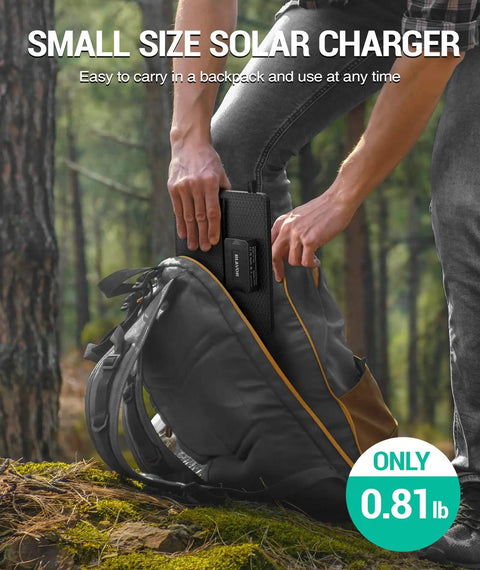 Person placing On The Go 10W Foldable Solar Charger With USB C And USB A Outputs into a backpack outdoors, showing small size.