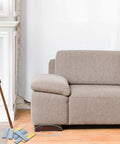 Eight Piece Premium High Density Self Adhesive PTFE Rectangle Furniture Glides under a sofa on hardwood floor, showing compact design.
