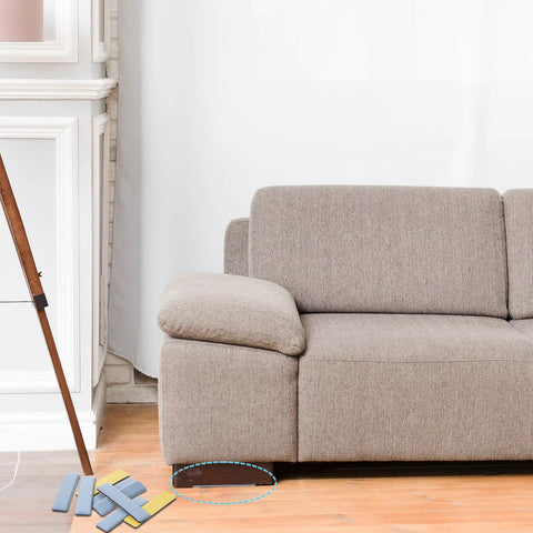 Eight Piece Premium High Density Self Adhesive PTFE Rectangle Furniture Glides under a sofa on hardwood floor, showing compact design.