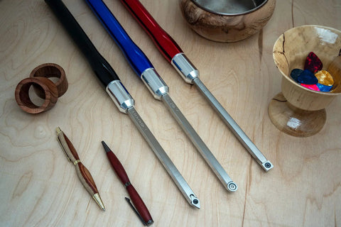 Top-down view of four 12-inch aluminum lathe turning tool handles with color-coded grips and blades.
