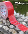 Two Pack Red Duct Tape Heavy Duty 9 Mil Thick 2 Inch By 30 Yard Roll waterproof feature shown on wet stones