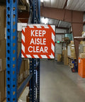 Magnetic Sign Holder Pack For 12 Inch Signs With 90 Degree Magnetic Base And 12 Inch Acrylic Strip For Door Frames And Metal Shelves Quick And Easy Sign Swaps In A 6 Pack 2.28 Inch Long By 0.79 Inch Wide By 13 Inch High displaying 'Keep Aisle Clear' sign in warehouse.