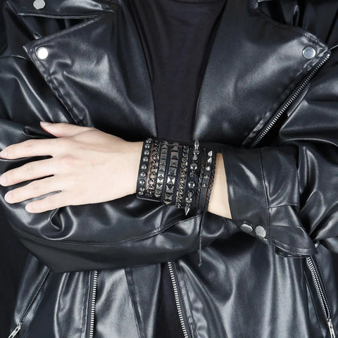 Badass 3 Piece Punk Gothic Leather Bracelet Set With Vintage Steampunk Spikes And Rivets Wide Adjustable Cuff Wristbands For Men And Women Daily Wear Gear worn on wrist with black leather jacket.