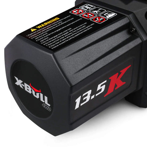 Heavy Duty 13500 Lb Electric Winch With Synthetic Rope Harness And Wireless Remote Control close-up of motor housing showing warning labels.
