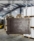 Four Wheel Trolley Assembly Rollers For One And Five Eighths Inch Wide Strut Channel installed, lifting metal structure in warehouse