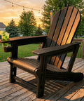 All Weather HDPE Adirondack Chair With Built In Cup Holder Tool Free No Screws Needed No Hassle Easy To Take Apart For Storage Wood Grain Slatted Look Snap Fit Design For Quick Assembly Classic Black Outdoor Patio Chair on wooden deck at sunset.