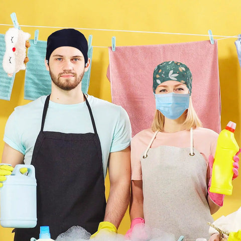 Two people wearing Six Pack Bouffant Scrub Caps With Buttons And Sweatband Unisex Surgical Nurse Hats, aprons, and gloves