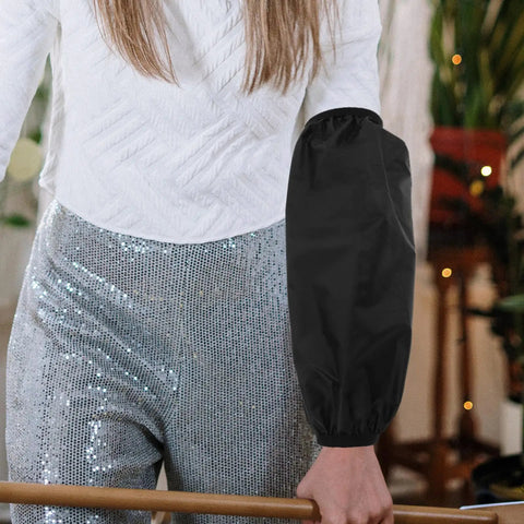 Slick Shield Waterproof Arm Sleeves on a person wearing black, showcasing heavy duty oilproof protection for daily tasks.