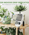 Solar Powered Drip Irrigation System With Automatic Timer For Pots And Indoor Plants, Emitter Stake Kit With USB Recharge Port, shown set up by potted plants indoors.