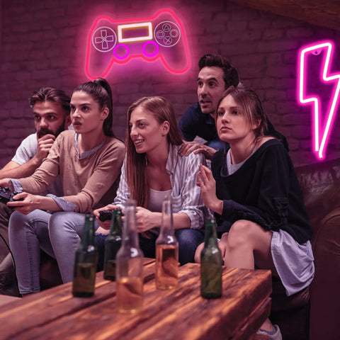 PS Controller Neon Light Sign For Gaming Rooms With Dimmer, LED Wall Decor in a cozy game room setting with friends.