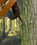 Heavy Duty Alloy Steel Tree Climbing Spikes Set With 350 Lb Load Capacity close-up on tree bark.