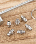 Six Pack Stainless Steel M6 X 1mm Straight Grease Fittings Zerk Nipples For Hydraulic Gear And Machinery on wooden surface